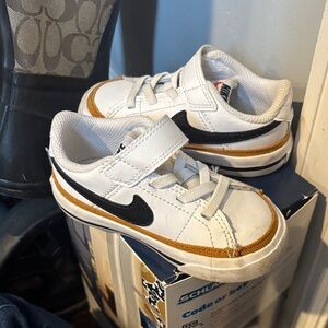 Nike Kids White, Black, and Gold Sneakers